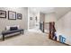 Bright hallway featuring carpet, bench, and wood stair railing at 2538 Tuffeto, Apex, NC 27502