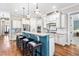 Modern kitchen featuring a large island with seating, granite countertops, stainless steel appliances, and custom cabinets at 2538 Tuffeto, Apex, NC 27502