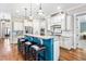Spacious kitchen with white cabinetry, granite countertops, stainless steel appliances, and breakfast bar with seating at 2538 Tuffeto, Apex, NC 27502