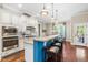 Bright eat-in kitchen boasts an island with bar seating, granite countertops, and modern appliances at 2538 Tuffeto, Apex, NC 27502
