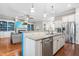 Island in eat-in kitchen has granite countertops, stainless steel appliances, and a view of the living room at 2538 Tuffeto, Apex, NC 27502