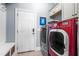 Laundry room with front load washer and dryer, tiled floors, white cabinets and access door at 2538 Tuffeto, Apex, NC 27502