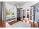 Office space with french doors, a view to foyer, large window, and area rug on wood floor at 2538 Tuffeto, Apex, NC 27502
