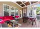 Relaxing screened-in porch with overhead lighting, outdoor furniture, and wooded scenery at 2538 Tuffeto, Apex, NC 27502