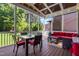 Screened porch with outdoor dining and seating area and wooded backyard views at 2538 Tuffeto, Apex, NC 27502