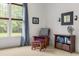 Bedroom sitting area with side table, upholstered reading chair and view to the yard at 2538 Tuffeto, Apex, NC 27502