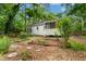 Expansive backyard featuring a screened porch, garden beds, mature trees, and lush greenery at 26 Rogerson Dr, Chapel Hill, NC 27517