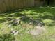 Inviting backyard featuring a stone fire pit surrounded by lush greenery and a wooden fence at 26 Rogerson Dr, Chapel Hill, NC 27517