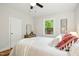 Sunlit bedroom boasts light walls and a ceiling fan at 26 Rogerson Dr, Chapel Hill, NC 27517