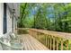 A lovely front deck with two chairs and a view of mature trees at 26 Rogerson Dr, Chapel Hill, NC 27517