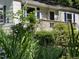 Exterior shot of home showing front deck with manicured landscaping at 26 Rogerson Dr, Chapel Hill, NC 27517