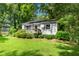 Attractive single-story home features a welcoming front porch, pretty landscaping, and inviting yard at 26 Rogerson Dr, Chapel Hill, NC 27517