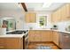 Well-lit kitchen with stainless steel appliances, light wood cabinets, and a subway tile backsplash at 26 Rogerson Dr, Chapel Hill, NC 27517