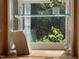 Close up of kitchen window featuring a small plant and natural lighting at 26 Rogerson Dr, Chapel Hill, NC 27517