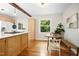 Bright kitchen boasts hardwood floors, a breakfast nook, and a view of the lush green backyard at 26 Rogerson Dr, Chapel Hill, NC 27517