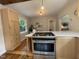 Kitchen features light wood cabinetry, stainless steel appliances and quartz countertops at 26 Rogerson Dr, Chapel Hill, NC 27517