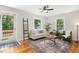 Cozy living room with hardwood floors, an area rug, a ceiling fan and great natural light at 26 Rogerson Dr, Chapel Hill, NC 27517