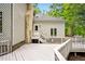 Wide backyard deck features a stone chimney, white railings, and convenient access to the yard at 2606 Sherbrooke Dr, Durham, NC 27712