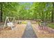 Backyard features a swing, gravel path, and table and chairs at 2606 Sherbrooke Dr, Durham, NC 27712