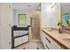 Bathroom features a tub, stand-up shower with gold trim, and neutral-toned double sink vanity at 2606 Sherbrooke Dr, Durham, NC 27712