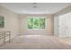Spacious bedroom features a ceiling fan, carpet flooring, a large window, and neutral walls at 2606 Sherbrooke Dr, Durham, NC 27712