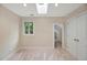 Bedroom with skylight, window, closet, and neutral carpet at 2606 Sherbrooke Dr, Durham, NC 27712