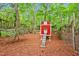 Backyard chicken coop with ramp and fenced enclosure on wooded property at 2606 Sherbrooke Dr, Durham, NC 27712