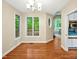 Bright dining room with hardwood floors, large windows and an open doorway that leads to the kitchen at 2606 Sherbrooke Dr, Durham, NC 27712