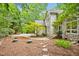Charming stone and siding home with a meticulously landscaped front yard and a stone walkway at 2606 Sherbrooke Dr, Durham, NC 27712