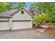 Stone and wood home with attached garage and stone walkway surrounded by green landscaping at 2606 Sherbrooke Dr, Durham, NC 27712