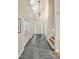 Bright foyer featuring a high ceiling, chandelier, stone tile floor, and staircase at 2606 Sherbrooke Dr, Durham, NC 27712