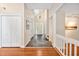 Open foyer with hardwood floors, staircase, coat closet, and a view of the front door at 2606 Sherbrooke Dr, Durham, NC 27712
