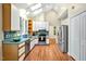 Well-lit kitchen with stainless appliances, skylights, and ample cabinet space at 2606 Sherbrooke Dr, Durham, NC 27712
