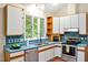 Functional kitchen featuring stainless steel appliances, white cabinetry, and natural light at 2606 Sherbrooke Dr, Durham, NC 27712
