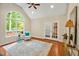 Cozy room featuring large windows, french doors, neutral walls, and hardwood floors at 2606 Sherbrooke Dr, Durham, NC 27712