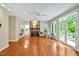 Spacious living room with a stone fireplace, large windows, access to the outdoor deck, and hardwood floors at 2606 Sherbrooke Dr, Durham, NC 27712