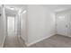 Bright hallway with light-colored wood flooring leading to various rooms and a back door at 2612 Glenbrook Dr, Durham, NC 27704