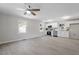 Open-concept living room and kitchen with modern gray flooring and stainless appliances at 2612 Glenbrook Dr, Durham, NC 27704