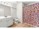 Full bathroom featuring a single sink vanity, toilet, and tub/shower combo with orange floral curtain at 2635 Asher View Ct, Raleigh, NC 27606