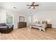 Inviting bedroom features bright natural light, a ceiling fan, a chair and a sizable dresser at 2635 Asher View Ct, Raleigh, NC 27606