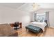 Bright bedroom featuring vaulted ceilings, wood floors, and a stylish upholstered bench at 2635 Asher View Ct, Raleigh, NC 27606