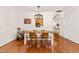 Charming dining area with hardwood floors and a stylish light fixture adjacent to the kitchen at 2635 Asher View Ct, Raleigh, NC 27606