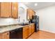 Functional kitchen with wood cabinets, a black refrigerator, and a wood floor at 2635 Asher View Ct, Raleigh, NC 27606