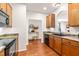 Open kitchen layout showcasing a sink, wooden cabinetry, and seamlessly connected living spaces at 2635 Asher View Ct, Raleigh, NC 27606
