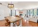 Open-concept living and dining area with hardwood floors, a fireplace, and abundant natural light at 2635 Asher View Ct, Raleigh, NC 27606