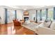 Cozy living room with fireplace, large windows, hardwood floors, and stylish seating arrangement at 2635 Asher View Ct, Raleigh, NC 27606