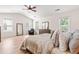 Bright main bedroom featuring a ceiling fan, hardwood floors, and multiple windows offering natural light at 2635 Asher View Ct, Raleigh, NC 27606