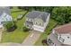 Aerial view of home with a manicured lawn, two-car garage, and mature trees at 2709 Banks Lake Ct, Fuquay Varina, NC 27526