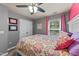 Vibrant bedroom with gray walls, colorful bedding, natural light from the window, and double closet at 2709 Banks Lake Ct, Fuquay Varina, NC 27526