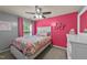 Cheerful bedroom with bright pink accent wall, gray walls, decorative wall art, and a ceiling fan at 2709 Banks Lake Ct, Fuquay Varina, NC 27526